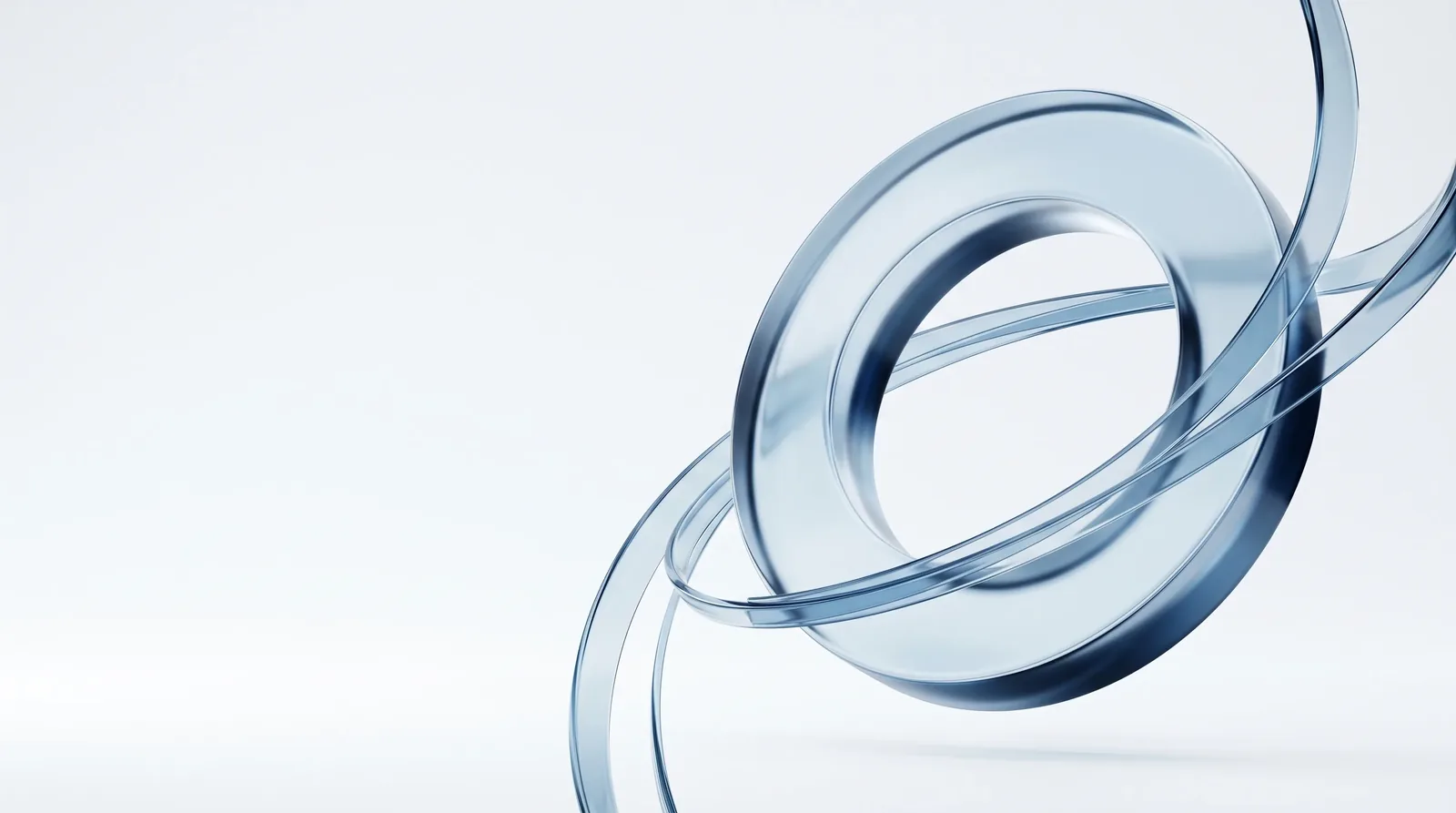 Soft navy and ice-blue glass forms layered over a calm gradient — an abstract brand visual.